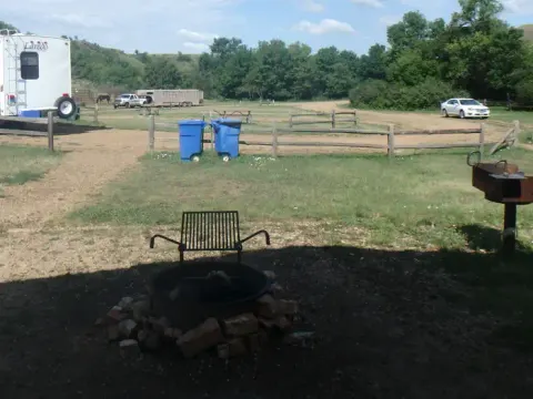 Site looking east from the picnic area with fire pit and grill in he foreground