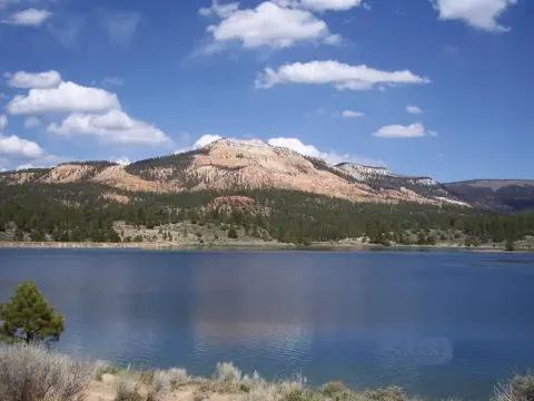 Pine Lake with pink cliffs in the background