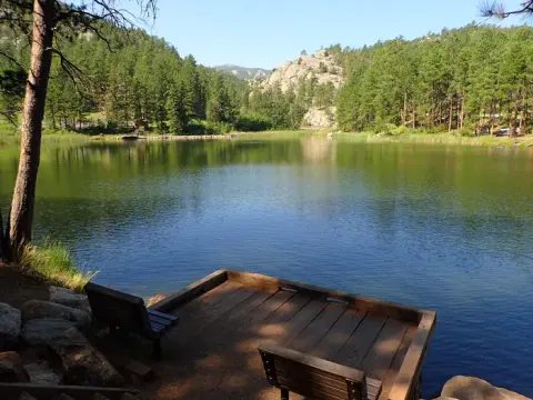 Fishing pier overlooking lake with benches