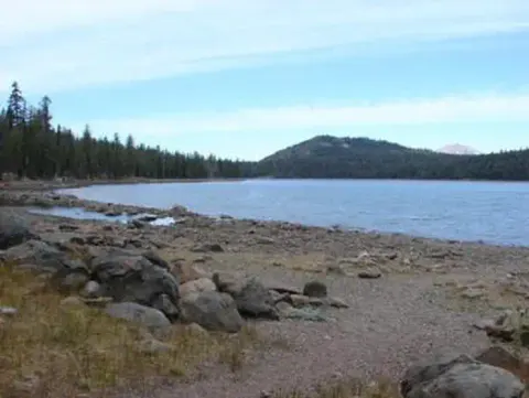 JUNIPER LAKE's Rocky Shoreline with peak in the background