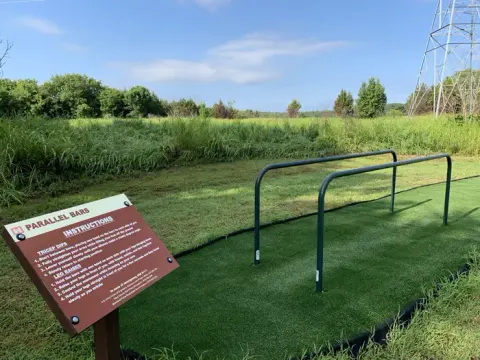 Unique to Keystone Lake, a mile long fitness trail located in Brush Creek offers obstacles. Featured is the parallel bars station which is located at one of four stations on the trail.