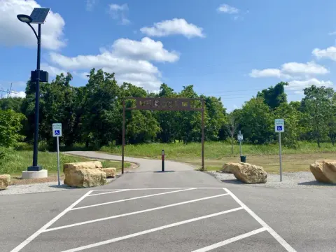 Unique to Keystone Lake, a mile long fitness trail located in Brush Creek offers obstacles. Featured is the entrance to the trail.