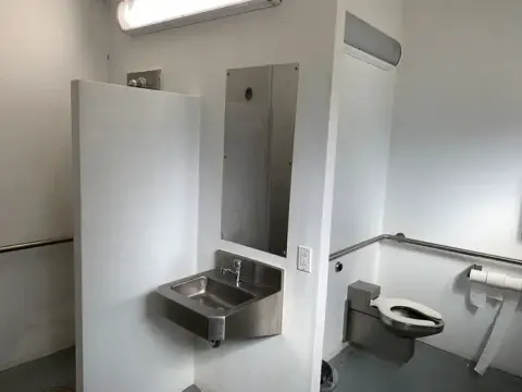 Toilet, sink, and shower all in one large space for convenience in the shower/restroom facility in Brush Creek.
