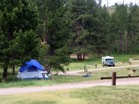 A view of a tent and an RV at Elk Mountain Campground