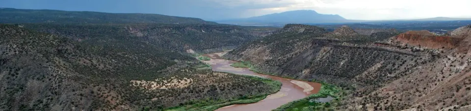 River flowing through a canyon with mountains in the distance