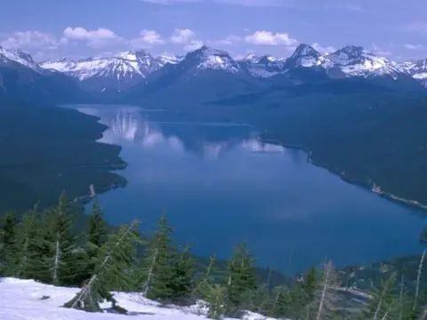 Lake McDonald surrounded by snow covered peaks.
