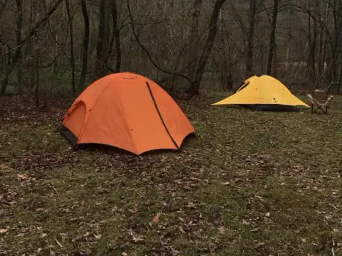 An orange and a yellow tent pitched at Round Spring