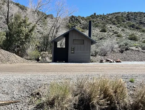 vault toilet on gravel road