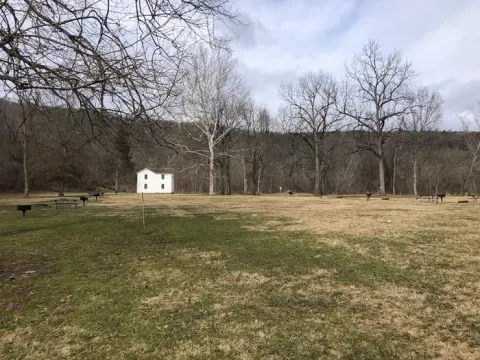 The grassy expanse of Paw Paw campground with the historic canal superintendent’s house