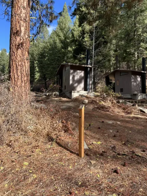 Steep dirt driveway leading to campsite and bathrooms