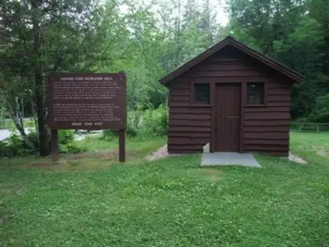 CCC era out building with interpretive sign
