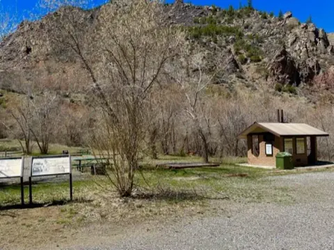 A view of East Portal Campground with wayside signs and restrooms