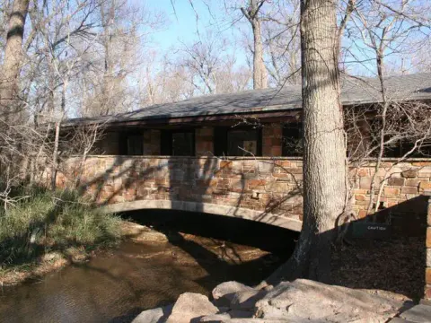 Travertine Creek flows under a stone bridge at the Travertine Nature Center