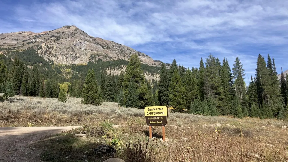 Campground sign with mountain peak