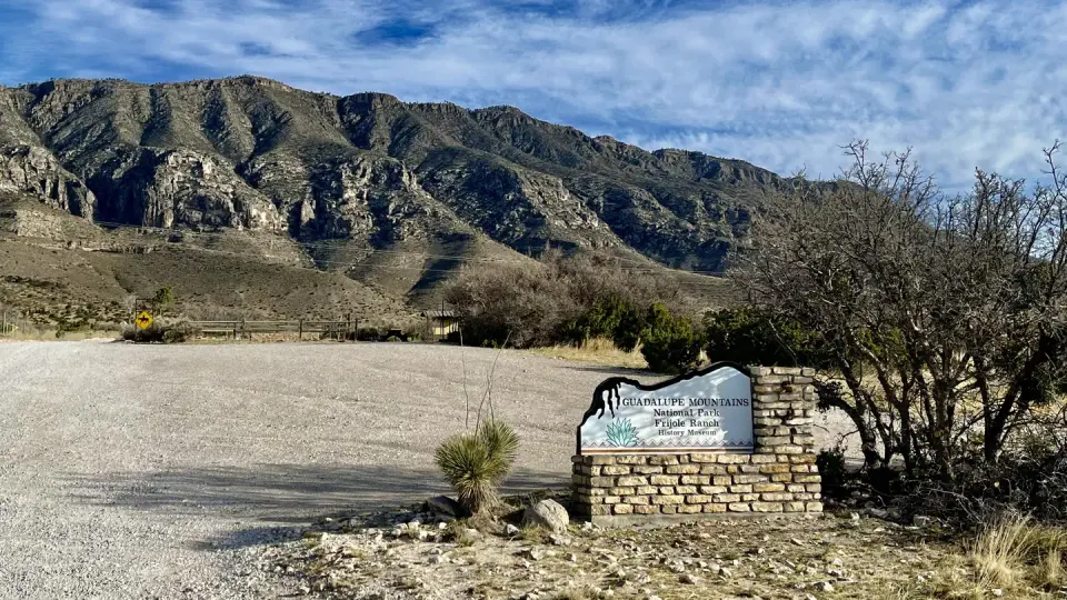 Entry sign to the Frijole Ranch area with view of the mountains in the background and the Frijole Horse Corral campground.