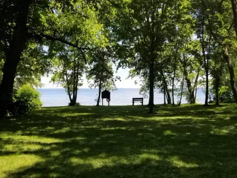 Bench and Beach Along Lake Shore