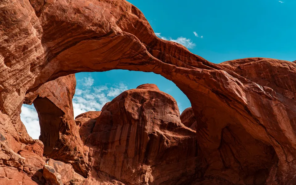 Majestic rock formations under a clear blue sky in Arches National Park, Utah.