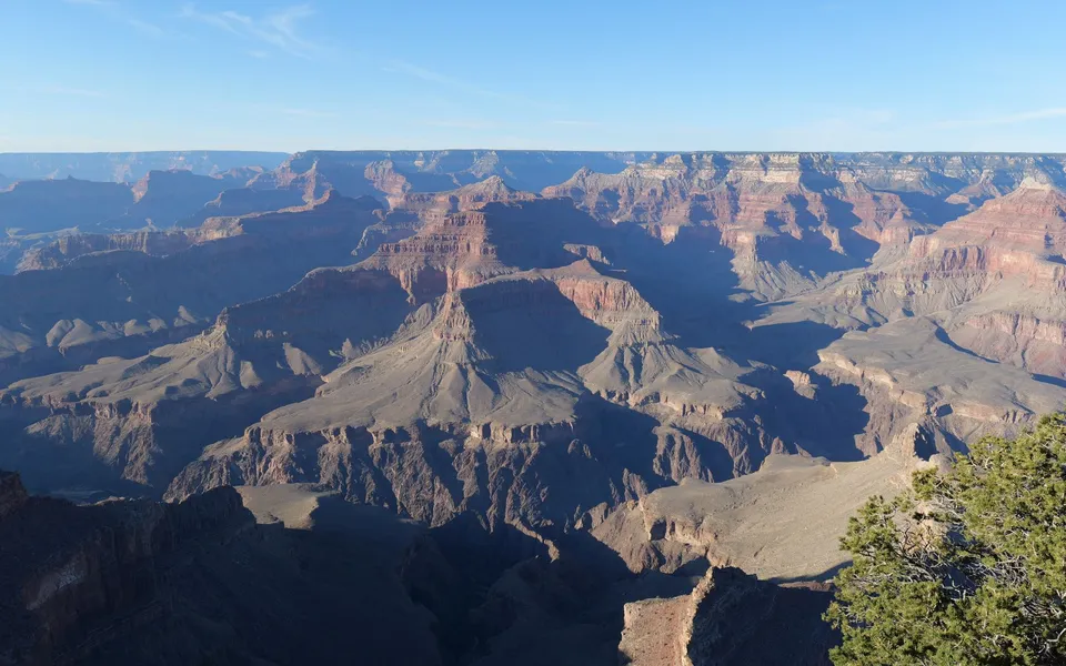 Captivating aerial view of the majestic Grand Canyon under clear skies.