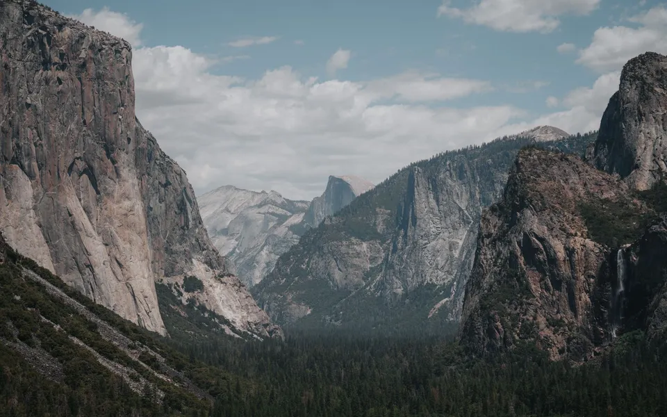Stunning landscape of Yosemite Valley with El Capitan and lush forest below.