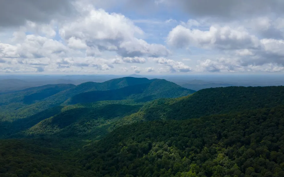 Majestic aerial view of the lush Blue Ridge Mountains under a cloudy sky in Georgia, USA.