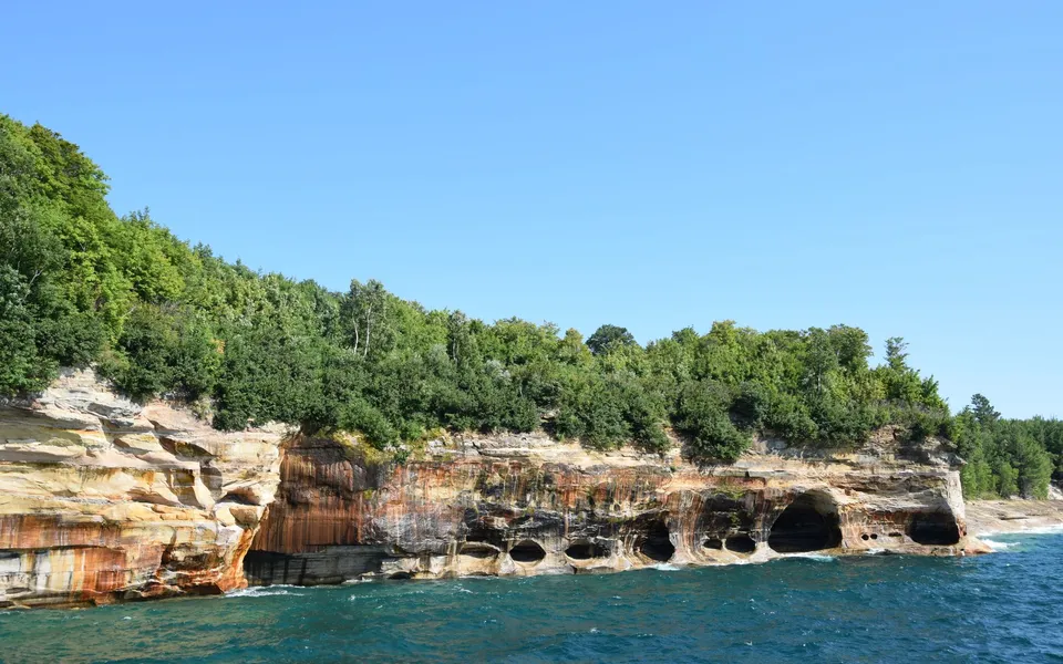 Stunning view of Pictured Rocks cliffs and clear blue water in Michigan's Upper Peninsula.