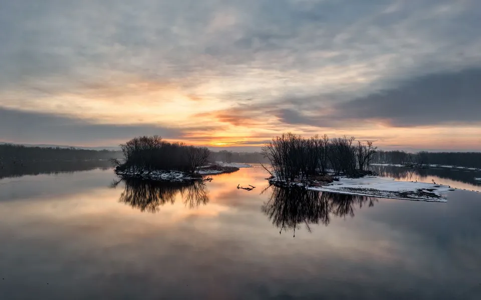 A tranquil winter sunset reflecting on the lake at Reads Landing, Minnesota.
